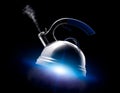 Tea kettle with boiling water on black background. Royalty Free Stock Photo
