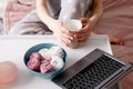 Tea, laptop and sweets at morning