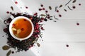 Tea leaves with lingonberry berries and a cup of tea on a white background with space for text. The concept of a healthy