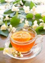 Tea with lemon and branches of a blooming jasmine