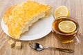 Tea with lemon, broken flat bread with cheese, sugar Royalty Free Stock Photo