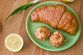 Tea with lemon and croissant for fresh spring breakfast