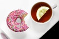 Tea with lemon and a delicious beautiful donut