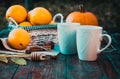 tea with lemon, honey, oranges, autumn leaves on woodenbackground