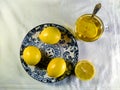 tea and lemons on a plate with a blue pattern on a white background, top view Royalty Free Stock Photo