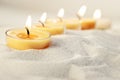 Tea light candles in sand Royalty Free Stock Photo
