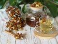 Tea made from dried flowers of calendula and marigolds on a wooden table and with green leaves in the background.The use of herbal Royalty Free Stock Photo
