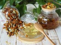 Tea made from dried flowers of calendula and marigolds on a wooden table and with green leaves in the background.The use of herbal Royalty Free Stock Photo