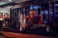 Tea master in kimono making natural tea in the dark room with a wooden interior, watching on tea leaves during brewing Royalty Free Stock Photo