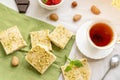 tea, milk, cakes, chocolate pieces, halva on a table Royalty Free Stock Photo