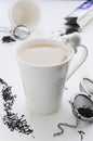 Tea with milk in cracked white porcelain cup with cat Royalty Free Stock Photo