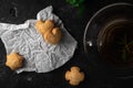 Tea with mint leaf with homemade coockies with ginger for Breakfast on the white backing paper and on the dark stone table