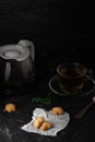 Tea with mint leaves and sweet coockies. Perfect choose for breakfast. Coockies on the white baking paper. Dark stone table for