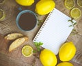 Tea. Mint Tea. Lemon Tea in a cup with lemons, blank notepad and biscotti Royalty Free Stock Photo