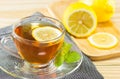 The tea with mint and lemon on wood background,warm toning, selecti