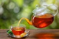 tea with mint pouring from teapot into cup Royalty Free Stock Photo