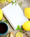 Tea. Mint Tea. Lemon Tea in a cup with lemons, blank notepad and biscotti Royalty Free Stock Photo