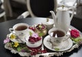 Tea in old porcelain cups, panakota dessert and raspberry on an old silver tray. Retro. Royalty Free Stock Photo