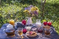 Tea, pancakes, milk and jam on the breakfast table in the autumn garden, close up Royalty Free Stock Photo