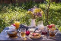 Tea, pancakes, milk and jam on the breakfast table in the autumn garden, close up Royalty Free Stock Photo