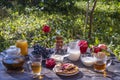 Tea, pancakes, milk and jam on the breakfast table in the autumn garden, close up Royalty Free Stock Photo