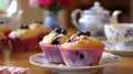 Tea party with blueberry muffins with powdered sugar and fresh berries. Generative AI