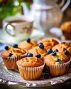 Tea party with blueberry muffins with powdered sugar and fresh berries. Generative AI