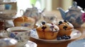 Tea party with blueberry muffins with powdered sugar and fresh berries. Generative AI