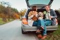 Tea party in car truck - loving couple with dog sits in car truck