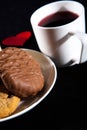 Tea cup of morning drink  waffles  biscuits and red heart on the table. Romantic breakfast Royalty Free Stock Photo