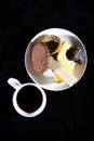 Tea cup of morning drink  waffles  biscuits on the black background. Romantic breakfast Royalty Free Stock Photo