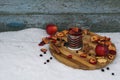 Tea party  flat lay top view with cup of hot tea, dry apple, berry of black chokeberry, cinnamon on wooden plate in garden Royalty Free Stock Photo