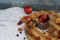 Tea party  flat lay top view with cup of hot tea, dry apple, berry of black chokeberry, cinnamon on wooden plate in garden Royalty Free Stock Photo