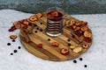 Tea party  flat lay top view with cup of hot tea, dry apple, berry of black chokeberry, cinnamon on wooden plate in garden Royalty Free Stock Photo