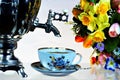 Tea party - samovar, Cup and garden flowers on a summer day. Samovar Ã¢â¬â creative metal vessel for boiling water and making tea,