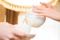 Tea party. Women pour green tea into a white Cup