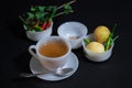 Tea is placed in the china cup with the spices and herbs on the back Royalty Free Stock Photo