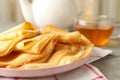 Tea, and plate of thin pancakes on gray table Royalty Free Stock Photo