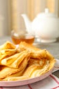 Tea, and plate of thin pancakes on gray table Royalty Free Stock Photo