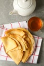 Tea, and plate of thin pancakes on gray table Royalty Free Stock Photo