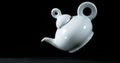 Tea-Pot falling on Black Background Royalty Free Stock Photo