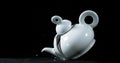 Tea-Pot falling and exploding on Black Background Royalty Free Stock Photo