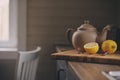 Tea pot and lemons in rustic grey kitchen interior. Slow living in country house concept