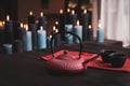 Tea pot with two cups on a wooden table with many candles burning on a background Royalty Free Stock Photo