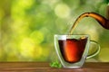 tea pouring from teapot into cup Royalty Free Stock Photo