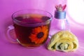 Tea and roll on pink background