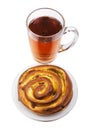 Tea with a rolled bun Royalty Free Stock Photo