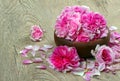 Tea rose flowers in a bowl on a wooden table Royalty Free Stock Photo