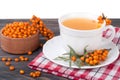 Tea of sea-buckthorn berries on wooden table isolated white background Royalty Free Stock Photo
