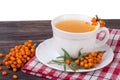 Tea of sea-buckthorn berries on wooden table isolated white background Royalty Free Stock Photo